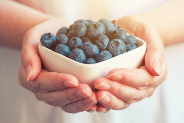 istock Woman offering blueberry blueberries 941842266