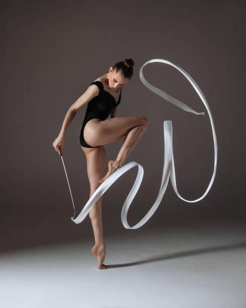 istock Young gymnast woman stretching and training 941842420