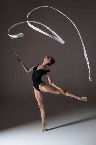 istock Young gymnast woman stretching and training 941842718