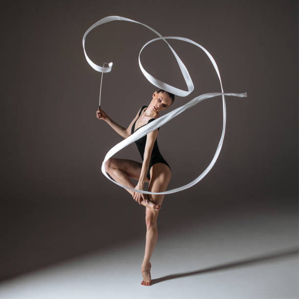 istock Young gymnast woman stretching and training 941843030