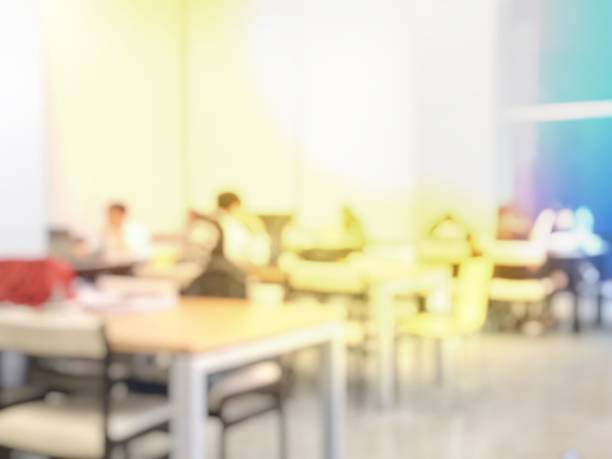 istock Education Concept: blurred image of student reading in modern library. Interior modern library for relax education in university. blurred university students training / reading / searching for books 941843572