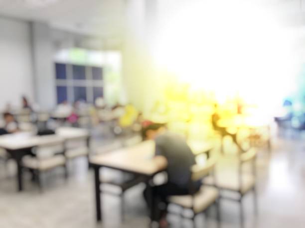 istock Education Concept: blurred image of student reading in modern library. Interior modern library for relax education in university. blurred university students training / reading / searching for books 941843620