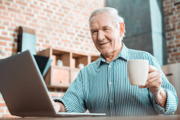 istock Cheerful senior man enjoying new technology 941846422