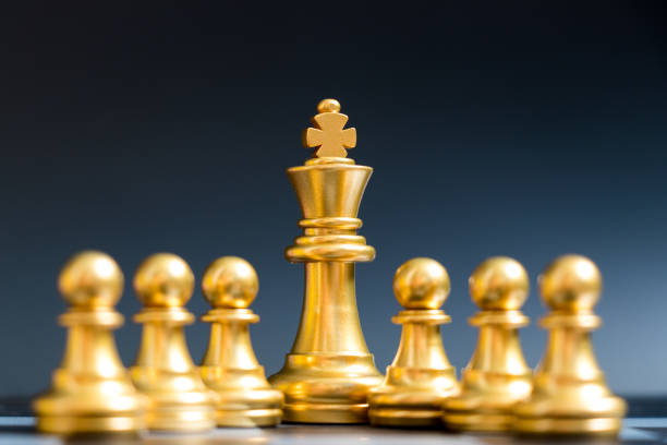 istock Gold king chess piece stand with pawn on black background 941846712