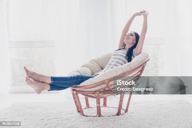 Good Day Happy Cute Pretty Woman Lying In The Armchair On The Weekend And Stretching Stock Photo - Download Image Now