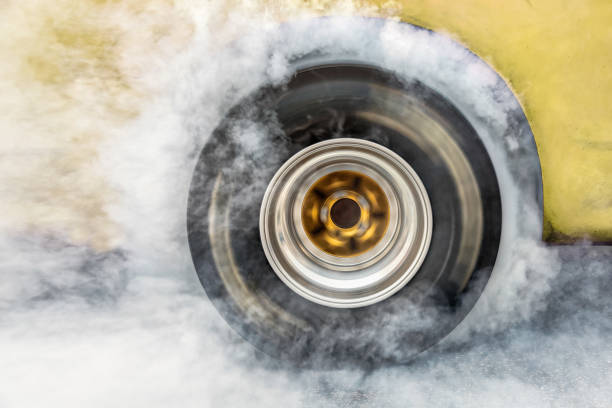 istock Drag racing car burn tire at start line 941848132