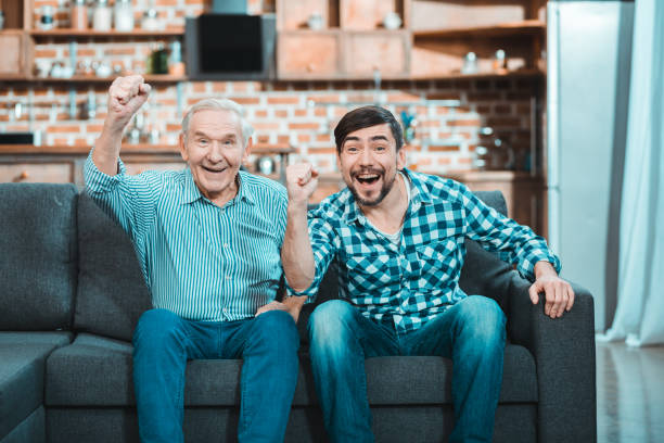 istock Happy positive men watching football 941851458