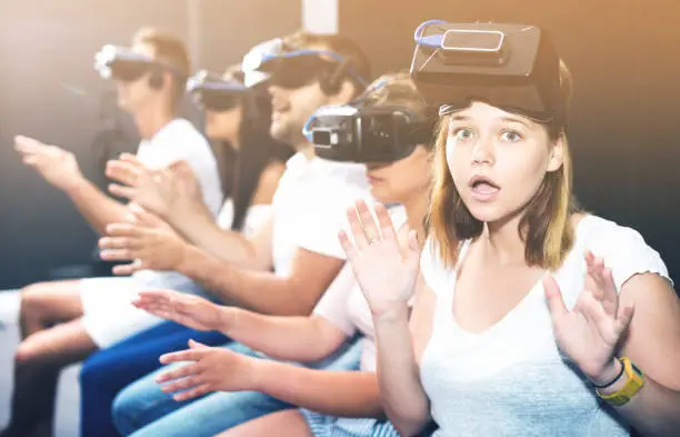 Photo of Portrait of frightened young girl after watching of exciting movie with VR glasses