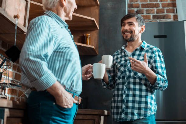 istock Cheerful brunette man looking at his father 941851676