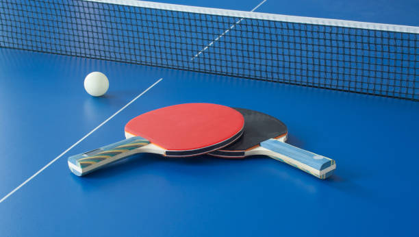 istock Table tennis black and red rackets on blue table 941851788