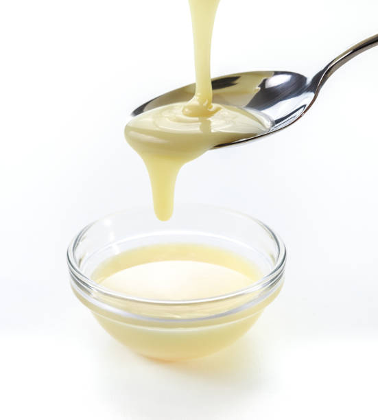 istock closeup pouring condensed milk with teaspoon 941852212