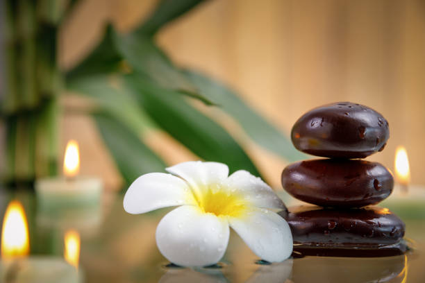 istock spa concept with candle, stone, flower and bamboo, relaxation 941852456