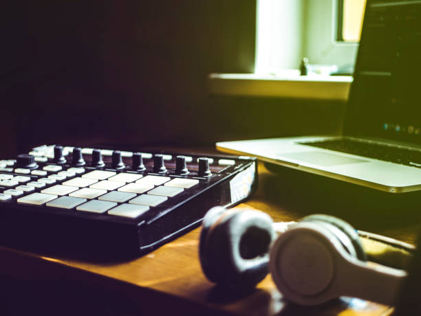 making hip hop beats on the drum machine controller at the home studio