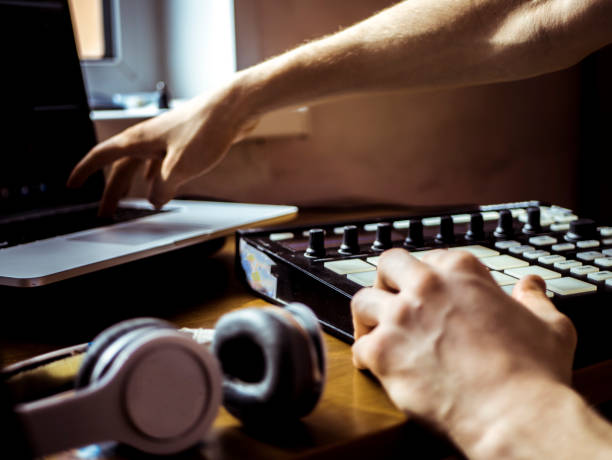 istock hand adjusting and controlling music on a laptop 941852686