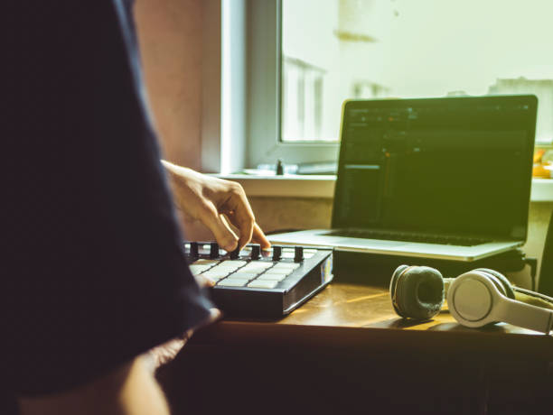 istock making hip hop beats on the drum machine controller at the home studio with laptop 941852726