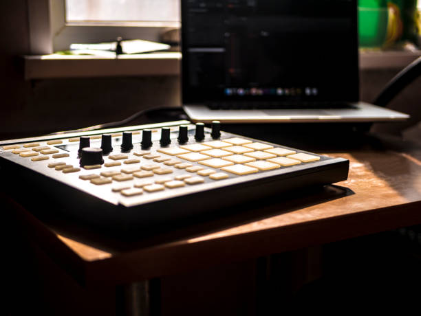 istock making hip hop beats on the drum machine controller at the home studio with laptop 941852960