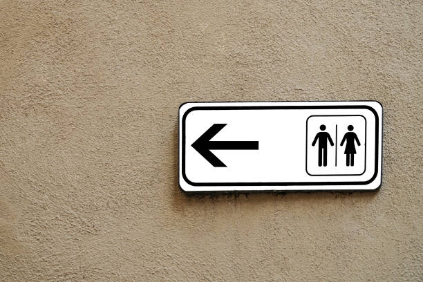 Toilet sign on red brick wall