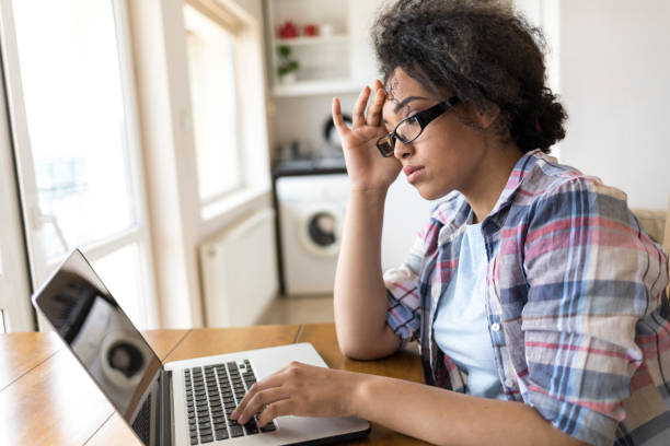 istock Woman sitting at home and using laptop 941858750