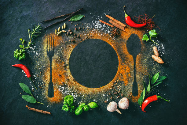 istock Herbs and spices on table with cutlery silhouette 941858828