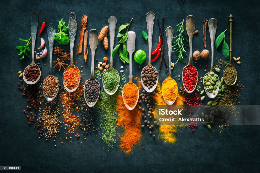 Herbs and spices for cooking on dark background Colourful various herbs and spices for cooking on dark background Spice Stock Photo