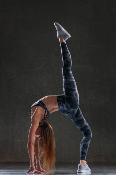 istock Young beautiful female dancer is posing in the studio 941863740