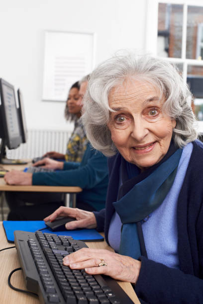 istock Portrait Of Senior Woman Attending Computer Class 941866184