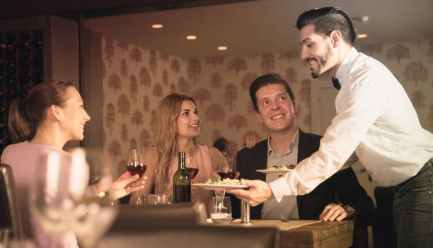 istock waiter bringing ordered dishes to guests 941866192