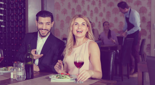 istock Loving pair enjoying evening meal and conversation in cozy restaurant 941866262