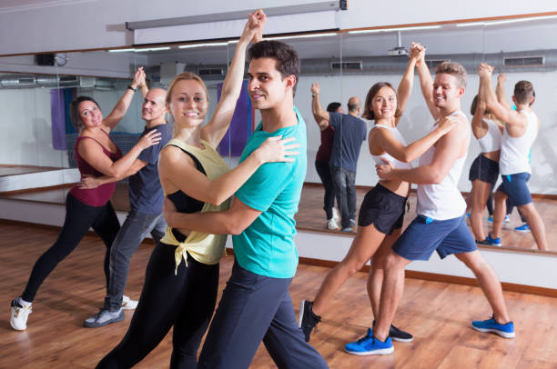 istock Group of energy people dancing salsa together 941870786