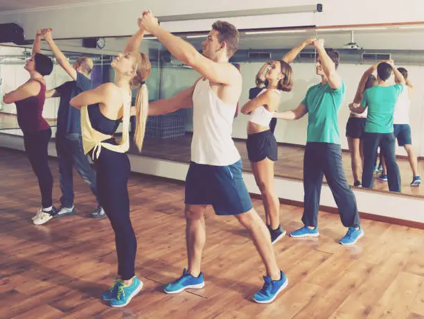 Photo of Dancing couples learning salsa