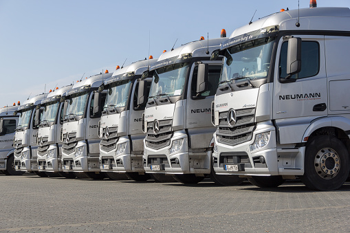 Burg / Germany - June 11, 2017: german Mercedes Benz Actros trucks from haulage firm Neumann stands in a row.