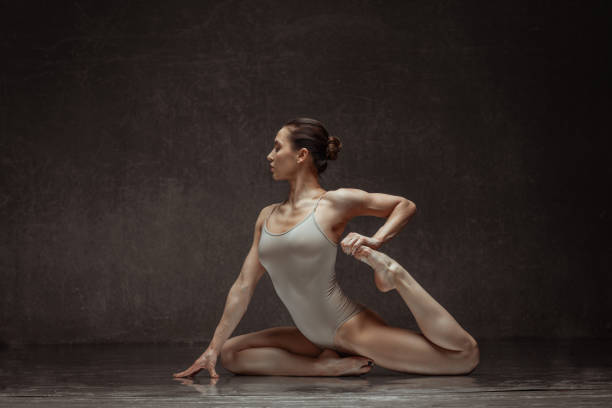 istock Young beautiful female dancer is posing in the studio 941871926