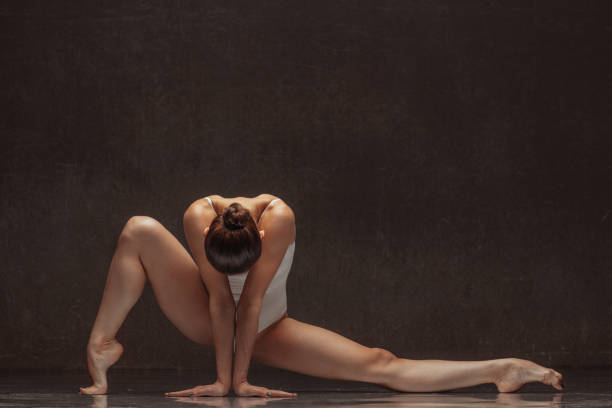 istock Young beautiful female dancer is posing in the studio 941871978
