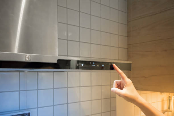 istock Woman's Hands pressing functional button on smoke vacuum for cooking 941872722