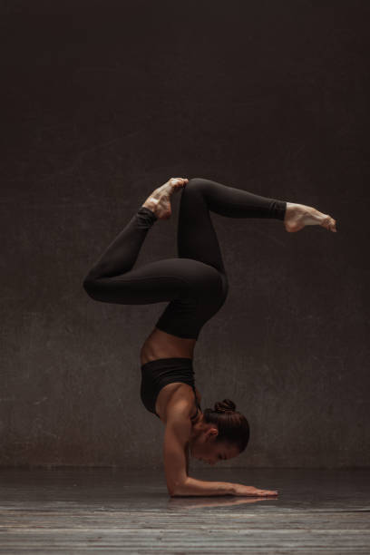 istock Young beautiful female dancer is posing in the studio 941874938