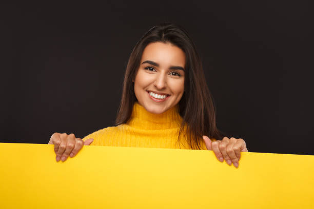 istock Charming woman with yellow banner 941875730
