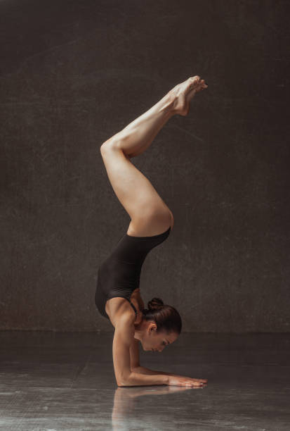 istock Young beautiful female dancer is posing in the studio 941876196
