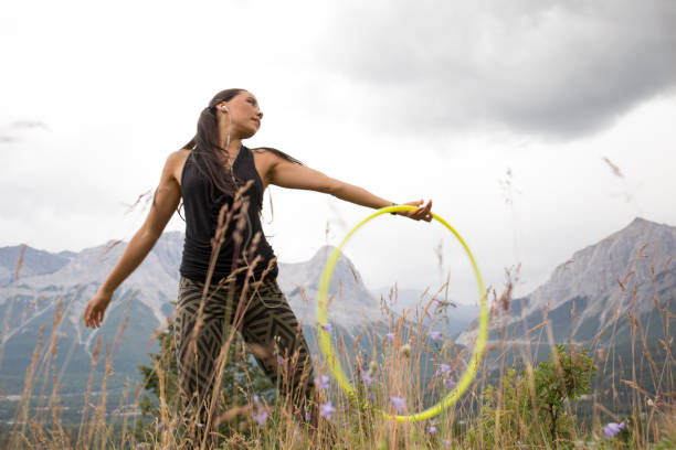 istock Native American woman dances with hoops, in mountains 941879400