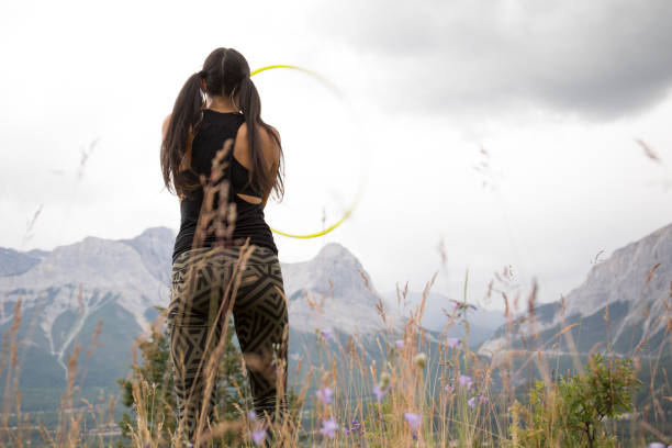 istock Native American woman dances with hoops, in mountains 941879548