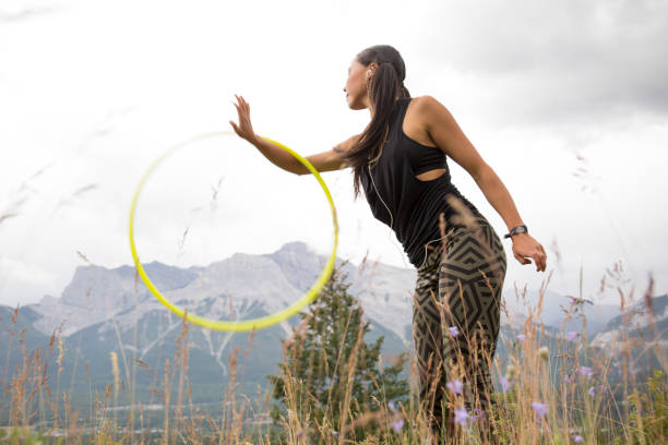 istock Native American woman dances with hoops, in mountains 941879610