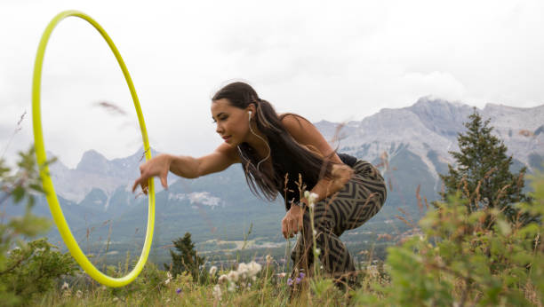 istock Native American woman dances with hoops, in mountains 941879958