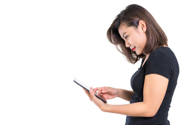 istock Young asian woman looking at blank screen tablet, for mobile phone or tablet application concept, isolated, white background 941880182