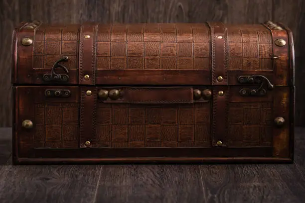 Beautiful decorative trunk treasure chest storage box on brown background