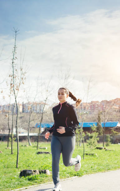 istock Woman Running in Park 941883122