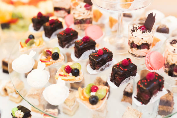 istock Delicious sweets on wedding candy buffet with desserts, cupcakes 941883668