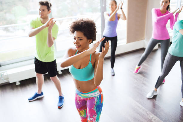 istock group of smiling people dancing in gym or studio 941883672