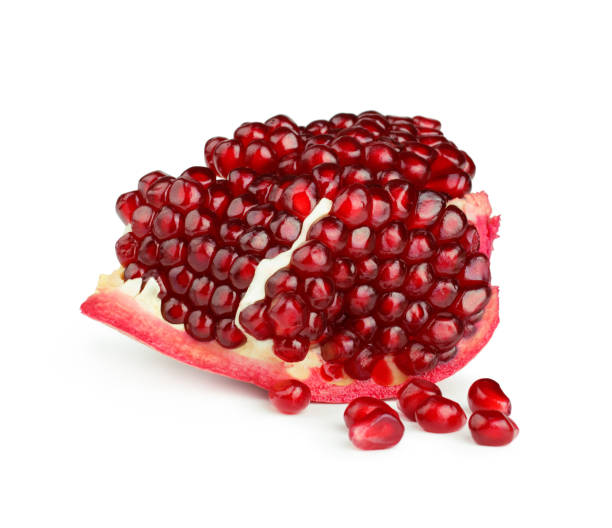 istock Piece of pomegranate isolated on white background 941883992