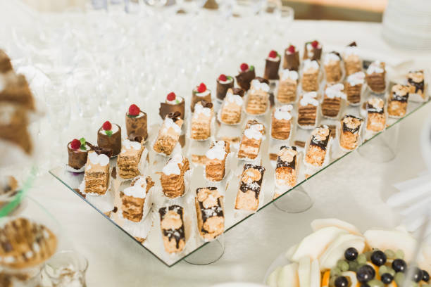 istock Delicious sweets on wedding candy buffet with desserts, cupcakes 941886328
