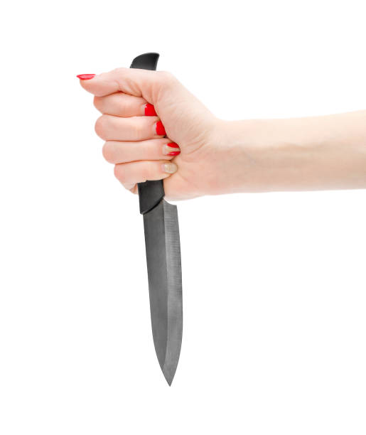 istock Woman hand holding knife. Isolated on white. 941890046