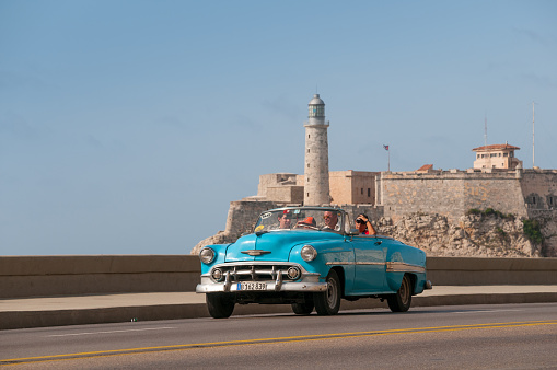 Classic American wagon with tourist strolling on an avenue of the old Havana. Havana cuba May 14 2015